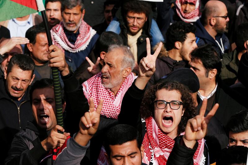 Demonstrators hold Jordanian national flag and chant slogans during a protest against a government's agreement to import natural gas from Israel, in Amman, Jordan. Reuters