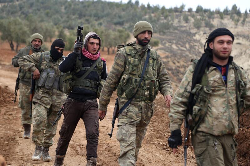 Turkish-backed Syrian rebel fighters are seen in the area of the Barsaya Hill, which overlooks both the Syrian town of Azaz, which is held by pro-Ankara rebels, and the Turkish town of Kilis just across the border, on January 24, 2018.
The Turkish military on January 20 launched operation "Olive Branch", its second major incursion into Syrian territory during the seven-year civil war. The operation, with Turkish war planes and artillery backing a major ground incursion involving Ankara-backed Syrian rebels and Turkish tanks, aims to oust the People's Protection Units (YPG) militia from its Afrin enclave. / AFP PHOTO / Nazeer al-Khatib