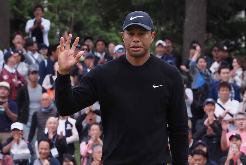 Tiger Woods  acknowledges cheers on the 5th hole. AFP