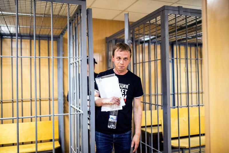 In this photo taken on Saturday, June 8, 2019, Ivan Golunov, a prominent Russian investigative reporter, who worked for the independent website Meduza, leaves the cage in a court room in Moscow, Russia. Golunov left the courtroom after the ruling to place him under house arrest until Aug. 7. In the court hearing, he denied being involved with drugs and said he would be willing to help investigators. (Evgeny Feldman/meduza.io via AP)