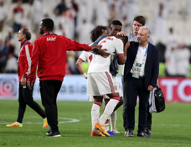 Abu Dhabi, United Arab Emirates - January 29, 2019: UAE's Fares Juma Al Saadi is consoled by manager Alberto Zaccheroni after loosing in the semi final between the UAE and Qatar in the Asian Cup 2019. Tuesday, January 29th, 2019 at Mohamed Bin Zayed Stadium Stadium, Abu Dhabi. Chris Whiteoak/The National