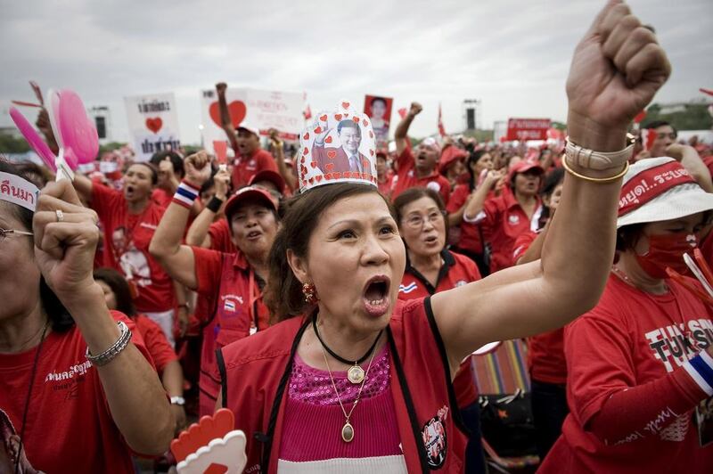 Red Shirt supporters of fugitive former premier, Thaksin Shinawatra, rally in Bangkok in 2009, above, in a call for him to be given a royal pardon. Nicolas Asfouri / AFP