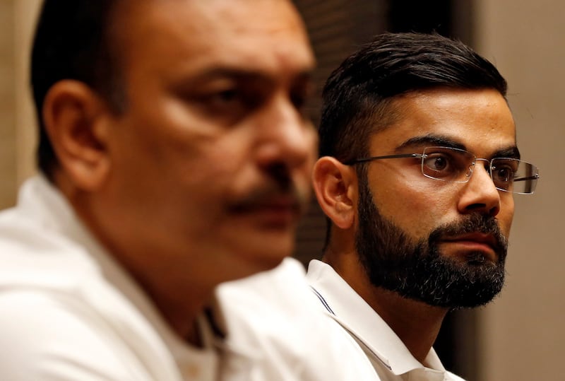 India's cricket team captain Virat Kohli and head coach Ravi Shastri listen to a question during a news conference in Mumbai, India July 19, 2017. REUTERS/Danish Siddiqui