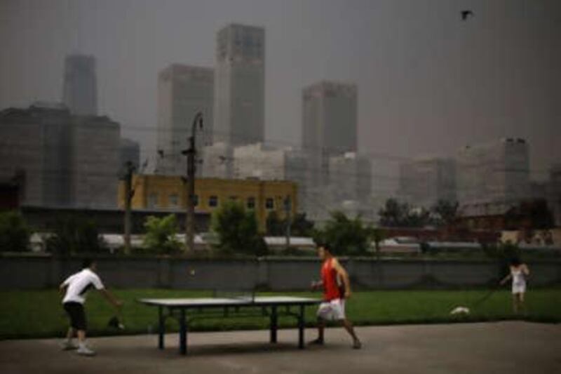 Chinese men play table tennis at their apartment compound in Beijing, China.