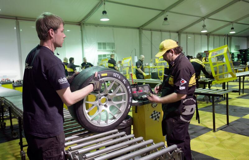 Dubai, United Arab Emirates, Jan 11 2013, 24h Dunlop , Night Dunlop Tyres - Dunlop tyre specialist supply the racing teams with tyre's . Each team will submit an order request for tyre's and Dunlop will warehouse all the teams tyre's at the race location. Dunlop works around the clock as teams race in the  2013 24h Dunlop series , Dubai. Mike Young / The National??