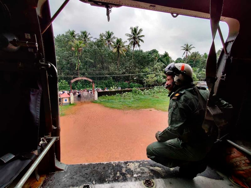 An Indian navy helicopter on the way to distribute relief material to flood-affected people in Kottayam district. AP