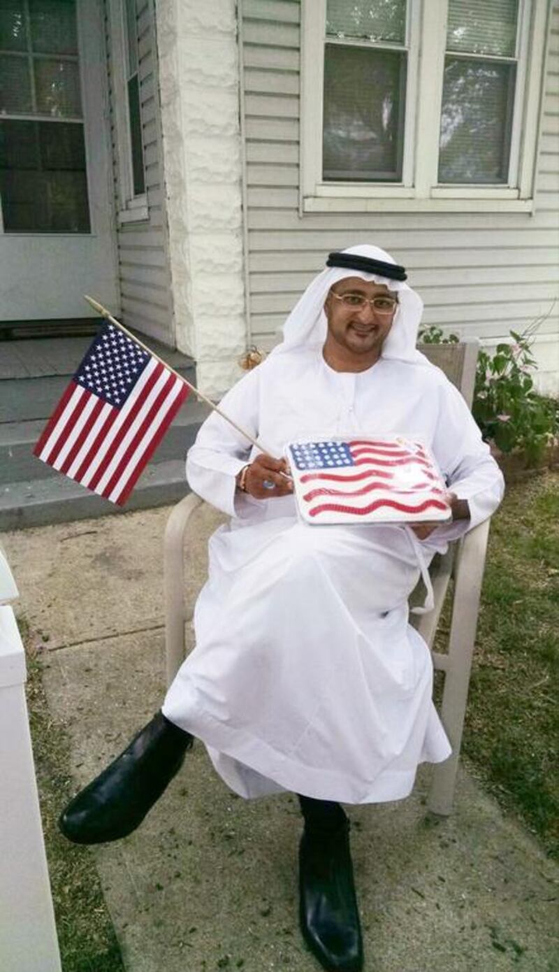 Ahmed Al Menhali celebrates American Independence Day in Lakewood, Ohio, last Sunday after Muslim American friends brought him a cake and flag. He has since returned to hospital. Courtesy Ahmed Al Menhali