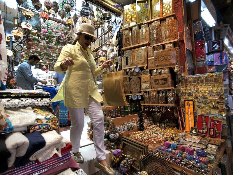 A tourist walks out of a traditional Islamic collectables shop in a souq in Muscat, Oman. Reuters