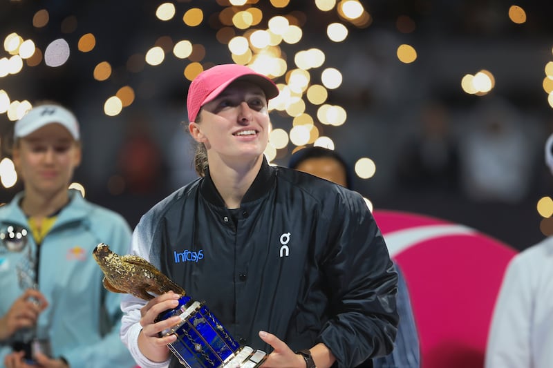 Poland's Iga Swiatek holds the Qatar Open trophy after defeating Kazakhstan's Elena Rybakina in the final on Saturday, February 17, 2024. AP