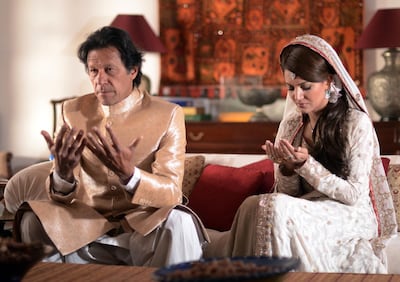 In this handout photograph released by the Pakistan Tehreek Insaf (PTI) party on January 8, 2015, Pakistani opposition leader Imran Khan (L) and new wife Reham Khan pose for a photograph as they pray during their wedding ceremony at his house in Islamabad. Pakistani opposition leader Imran Khan wed a TV journalist in a simple ceremony at his Islamabad home January 8, ending years of speculation surrounding the former playboy cricketer widely considered his country's most eligible man. AFP PHOTO/PAKISTAN TEHREEK INSAF (PTI) PARTY-----EDITORS NOTE---- RESTRICTED TO EDITORIAL USE MANDATORY CREDIT "AFP PHOTO/PAKISTAN TEHREEK INSAF (PTI) PARTY" NO MARKETING NO ADVERTISING CAMPAIGNS - DISTRIBUTED AS A SERVICE TO CLIENTS / AFP PHOTO / PTI / HO