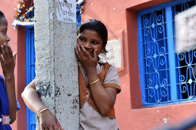 Ganga Kalshetty, 12, smiles as she jokes outside of the leprosy colony.