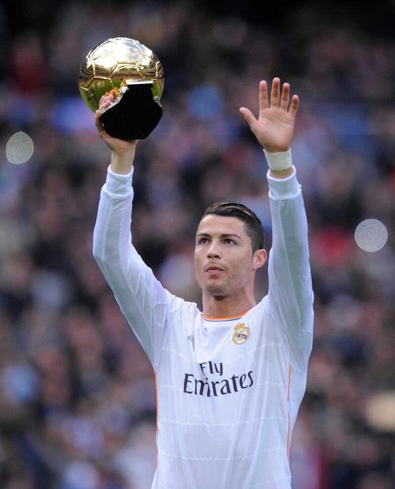 MADRID, SPAIN - JANUARY 25:  Cristiano Ronaldo of Real Madrid CF holds the Ballon d'Or 2013 award prior to he start of the La Liga match between Real Madrid CF and Granada CF at Santiago Bernabeu stadium on January 25, 2014 in Madrid, Spain.  (Photo by Denis Doyle/Getty Images)