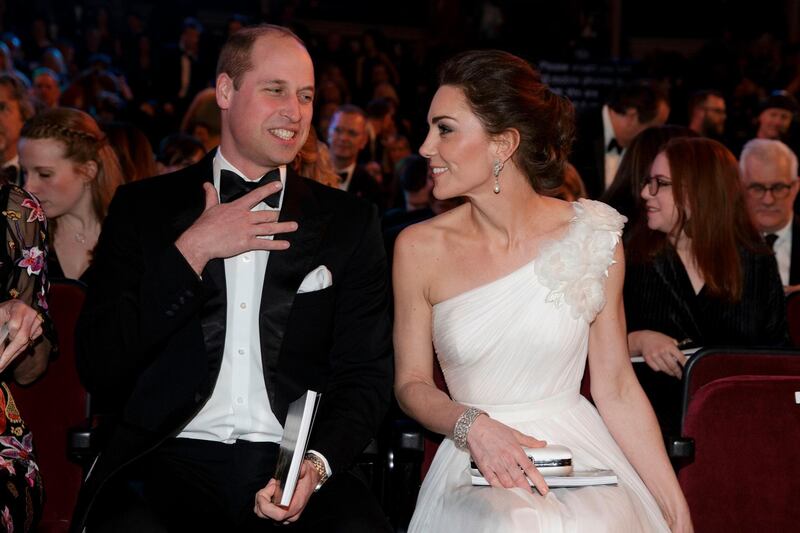 Prince William, Duke of Cambridge, and  Catherine, Duchess of Cambridge, settle in their seats at the British Academy Film Awards 2019. AFP