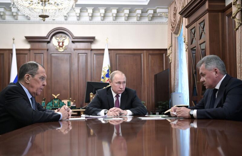 Russia's President Vladimir Putin (C) attends a meeting with Russia's Foreign Minister Sergei Lavrov (L) and Defence Minister Sergei Shoigu in Moscow on February 2, 2019. President Putin on February 2 said Russia was suspending its participation in a key Cold War-era missile treaty in a mirror response to a US move the day before. Moscow and Washington have long accused the other of violating the Intermediate-Range Nuclear Forces agreement. / AFP / Sputnik / Alexey NIKOLSKY
