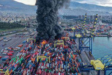 TOPSHOT - This handout photograph taken and released by Turkish agency DHA (Demiroren News Agency) shows smoke rising from burning containers at the harbor of Iskenderun in Hatay, a day after a 7. 8-magnitude earthquake struck the country's southeast, on February 7, 2023.  - Rescuers in Turkey and Syria braved frigid weather, aftershocks and collapsing buildings, as they dug for survivors buried by an earthquake that killed more than 5,000 people.  Some of the heaviest devastation occurred near the quake's epicentre between Kahramanmaras and Gaziantep, a city of two million where entire blocks now lie in ruins under gathering snow.  (Photo by Handout  /  DHA (Demiroren News Agency)  /  AFP)  /  - Turkey OUT  /  RESTRICTED TO EDITORIAL USE - MANDATORY CREDIT "AFP PHOTO  /   DHA (Demiroren News Agency) " - NO MARKETING NO ADVERTISING CAMPAIGNS - DISTRIBUTED AS A SERVICE TO CLIENTS