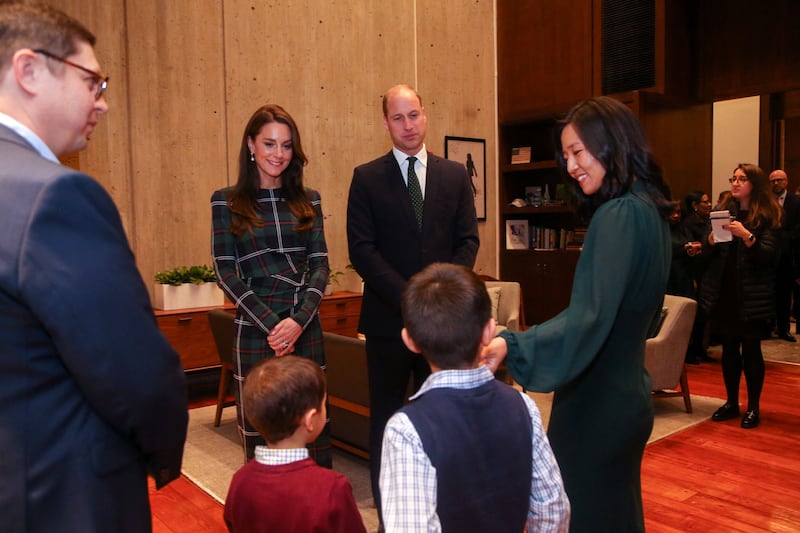 Ms Wu and her family chat with the British royal couple. AFP