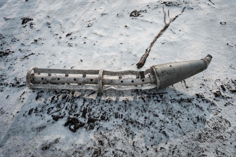A casing of a cluster bomb rocket lies on the snow-covered ground in Zarichne, Ukraine, on February 6. AFP