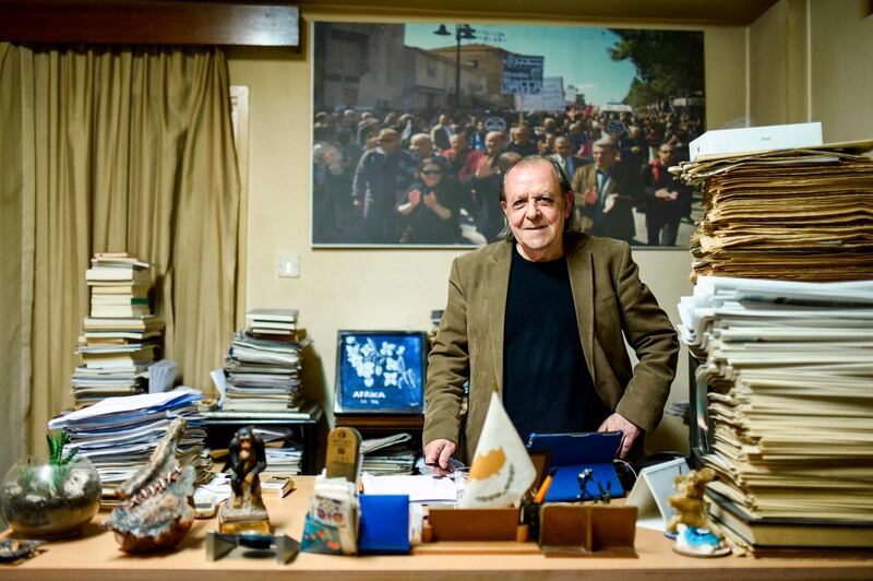 Sener Levent, chief editor of Afrika Gazetesi newspaper, poses for a picture in his office at the paper's headquarters in the northern side of the Cypriot capital Nicosia in the self-proclaimed Turkish Republic of Northern Cyprus (TRNC), on December 13, 2018. Jail time and angry mobs -- editor Sener Levent has paid a price for challenging the might of Turkey's President Recep Tayyip Erdogan and local authorities in breakaway northern Cyprus with his newspaper. In January, hundreds of protesters attacked the offices of the newspaper -- a tiny daily with a 1,500 circulation in a statelet of around 300,000 people -- after it ran an article criticising a Turkish military offensive against the Kurdish border enclave of Afrin in Syria. / AFP / Amir MAKAR
