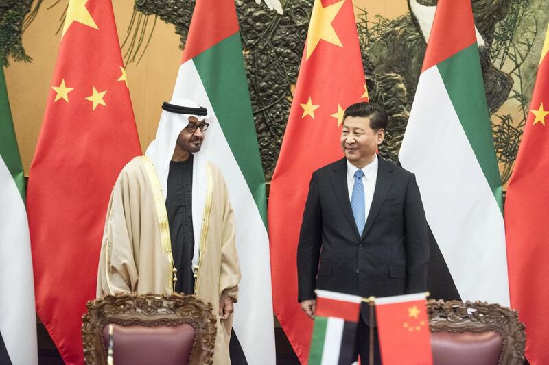 Sheikh Mohammed bin Zayed al-Nahyan (L), Crown Prince of Abu Dhabi and UAE's deputy commander-in-chief of the armed forces meets Chinese President Xi Jinping (R) during a signing ceremony at the Great Hall of the People in Beijing on December 14, 2015.  AFP PHOTO / POOL / FRED DUFOUR / AFP PHOTO / POOL / FRED DUFOUR
