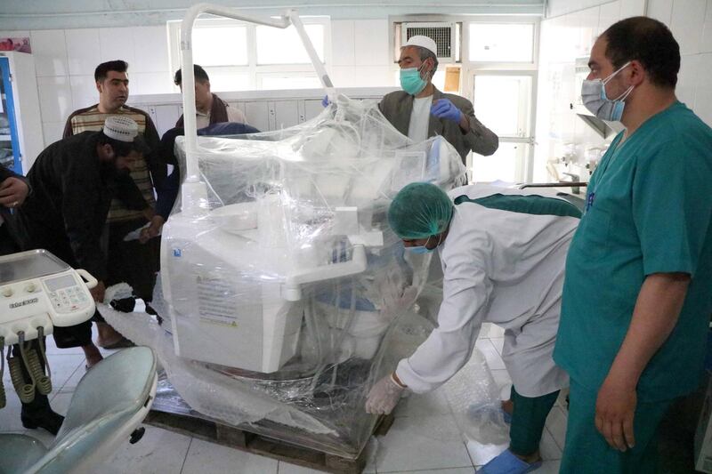 epa08492935 Afghan hospital staff unload dental medical equipment donated by NATO's forces to district hospital in Herat, Afghanistan, 18 June 2020.  EPA/JALIL REZAYEE