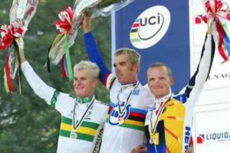 David Millar, center, from Great Britain, celebrates his victory with silver medallist Michael Rogers, left, from Australia, and bronze medallist Uwe Peschel, right, from Germany, at the elite men time trials event at the World Road Cycling Championships in Hamilton, Ontario, Thursday, Oct. 9, 2003. (AP Photo/Ryan Remiorz)