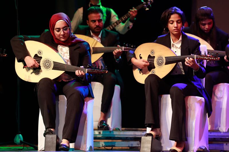 Iraqi musicians play oud during a concert at Al Rasheed theatre in Baghdad