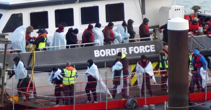 People thought to be migrants are taken on a rescue vessel into Dover, south-east England. PA