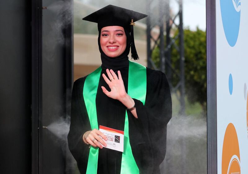 Ajman, United Arab Emirates - Reporter: Anam Rizvi. News. A student goes through a sterilisation booth during her drive through graduation from Ajman University because of Covid-19. Wednesday, February 10th, 2021. Ajman. Chris Whiteoak / The National