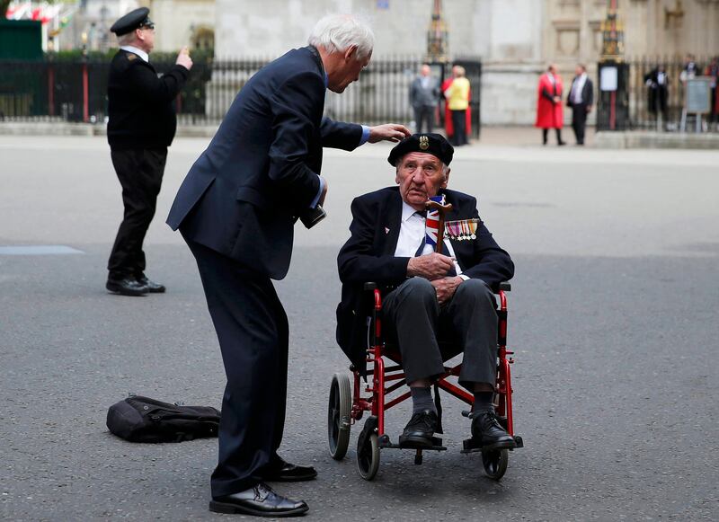 A veteran has his beret adjusted before the start of an armed forces parade in central London on May 10, 2015. AFP