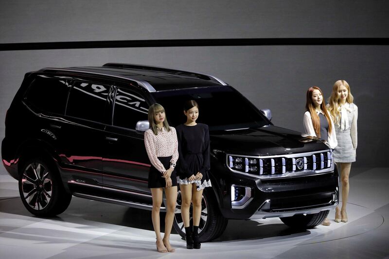 Members of K-pop idol group Black Pink pose for photographs with Kia Motors' Mohave. Reuters / Kim Hong-Ji