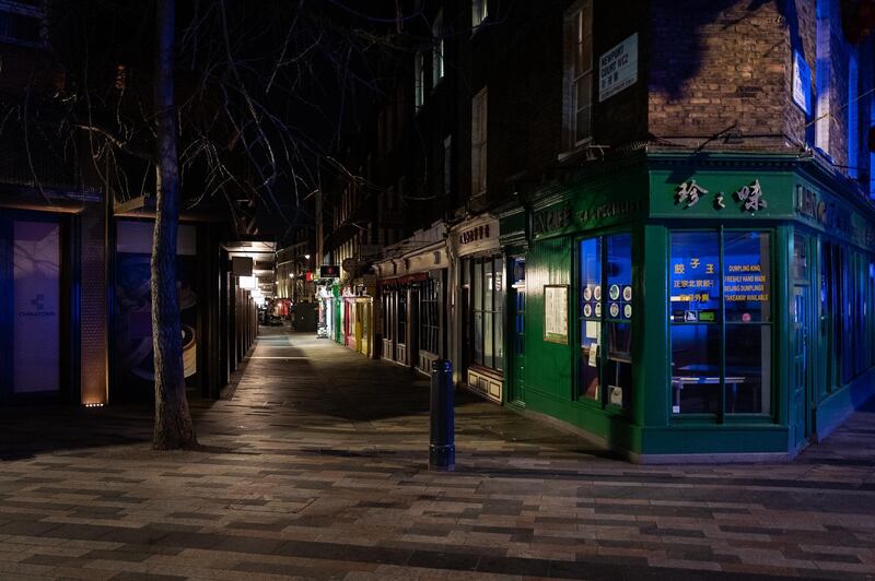 Empty streets and alleyways are seen around Chinatown at what would usually be a busy period of Friday night revelry in London, England. Getty Images