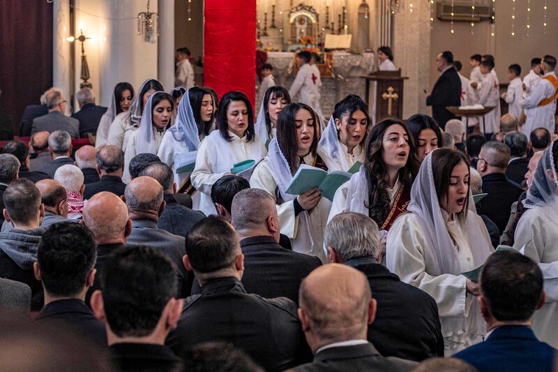 Female worshippers chant at Christmas morning mass in the Syriac Orthodox Church of the Virgin Mary in Qamishli, Syria.  AFP