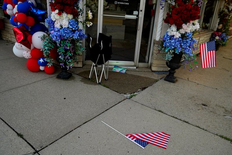 A US  flag and a chair lie abandoned along the parade route. Reuters