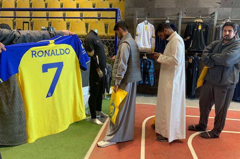 A fan holds a jersey bearing the name of Portugal star Cristiano Ronaldo and his famous number 7, at the Al Nassr FC shop in Riyadh. Ronaldo has signed a deal with the Saudi club in a deal believed to be worth more than $200 million. AFP