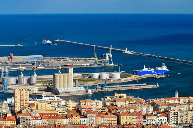 View of the commercial port of Sete with the houses of the city centre in the foreground and the silos, dikes and quays in the background. (Photo by: Andia/UIG via Getty Images)