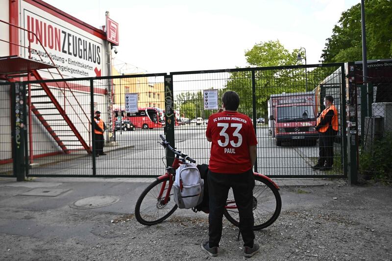 A Bayern Munich supporter stands at the closed entrance to the Stadion An der Alten Foersterei. AFP