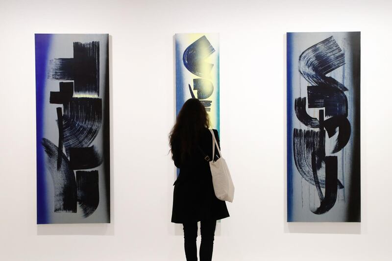 A person takes a picture of paintings by German-French painter Hans Hartung at the Musee d'Art Moderne de Paris. AFP