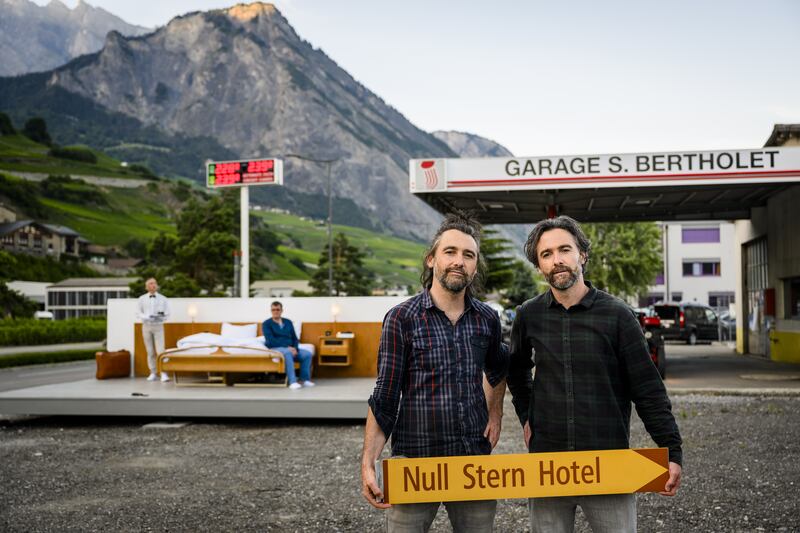 The artists outside their 'anti-idyllic' 'zero star hotel'. EPA