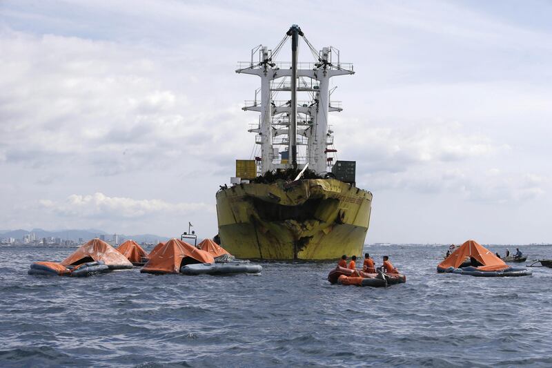 A cluster of life rafts floate near the cargo ship Sulpicio Express Siete with its damaged bow a day after it collided with a passenger ferry off the waters of Talisay city, Cebu province in central Philippines, Saturday Aug. 17, 2013. Divers combed through a sunken ferry Saturday to retrieve the bodies of more than 200 people still missing from an overnight collision with a cargo vessel near the central Philippine port of Cebu that sent passengers jumping into the ocean and leaving many others trapped. At least 28 were confirmed dead and hundreds rescued. The captain of the ferry MV Thomas Aquinas, which was approaching the port late Friday, ordered the ship abandoned when it began listing and then sank just minutes after collision with the MV Sulpicio Express, coast guard deputy chief Rear Adm. Luis Tuason said. (AP Photo/Bullit Marquez) *** Local Caption ***  Philippines Ferry Collision.JPEG-05492.jpg