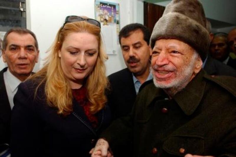 Palestinian President Yasser Arafat (R), assisted by his wife Suha (2nd L) and two aides, leaves his West Bank office in Ramallah, before flying to France, in this file photo provided to Reuters on October 29, 2004. The Palestinian Authority agreed on July 4, 2012, to the exhumation of Arafat's body after new allegations that he was poisoned with the radioactive element polonium-210 in 2004. REUTERS/Hussein Hussein/Handout/Files (WEST BANK - Tags: POLITICS OBITUARY) *** Local Caption ***  JER40_PALESTINIANS-_0704_11.JPG