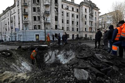 Ukrainians repair damage following a missile attack in Kyiv. AFP