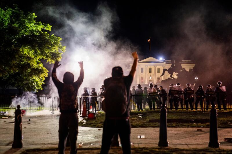 Protesters confront police outside the White House in Washington DC during a demonstration over the death of George Floyd.  EPA