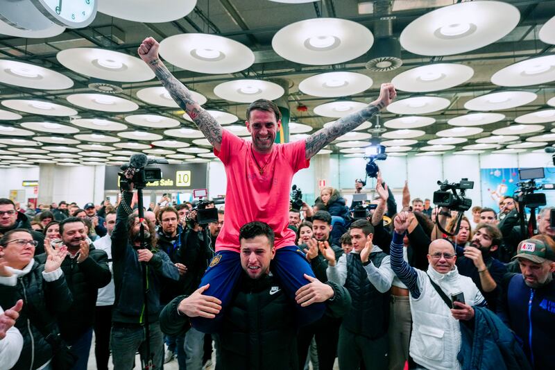 Santiago Sanchez celebrates with relatives and friends after arriving at Madrid-Barajas Airport. EPA