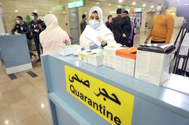 Egyptian Quarantine Authority employees prepare to scan body temperature for incoming travellers at Cairo International Airport on February 1, 2020, amidst efforts to detect possible cases of SARS-like "Wuhan coronavirus" (novel coronavirus 2019-nCoV).  / AFP / -
