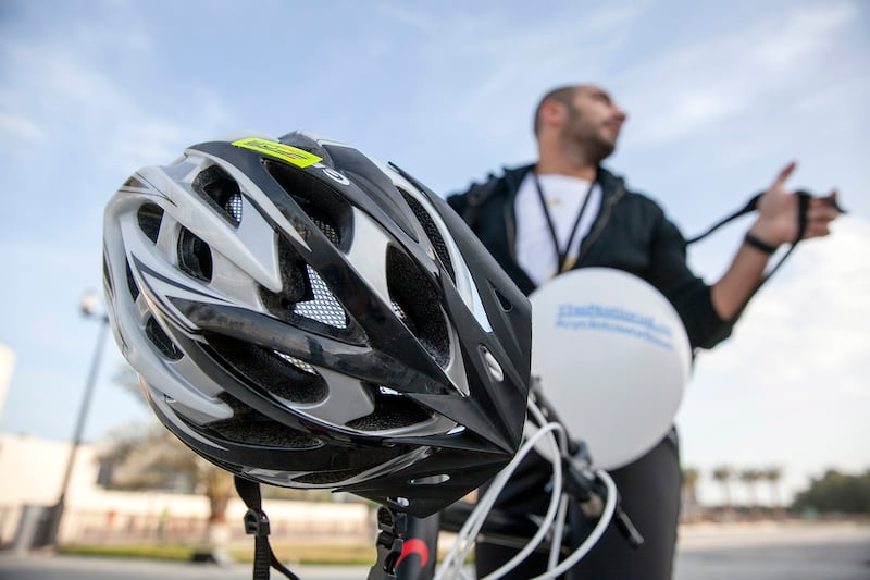 ABU DHABI, UNITED ARAB EMIRATES, Jan. 13, 2015:  
Staying safe and riding with a helmet, Ehab Haddad, a sales manager at the Abu Dhabi Media, stops by the Khalifa Park CycletoworkUAE park-and-cycle station as he participates in The National's health campaign #cycletoworkUAE on Tuesday morning, Jan. 13, 2015.  (Silvia Razgova / The National)  /  Usage:  Jan. 13, 2015  /  Section: NA   /  Reporter:  Anwar HajiKaram *** Local Caption ***  SR-150113-cycletowork23.jpg