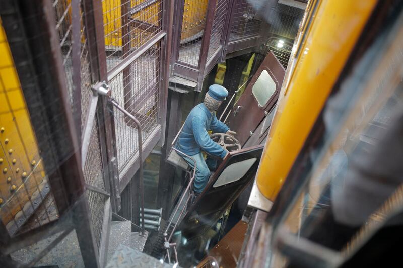 A mannequin representing the old version of the lift operator outside the elevator's cabin of the Tour Eiffel. AP