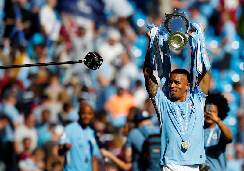 Manchester City's Gabriel Jesus celebrates with the trophy after winning the Premier League title. Phil Noble / Reuters