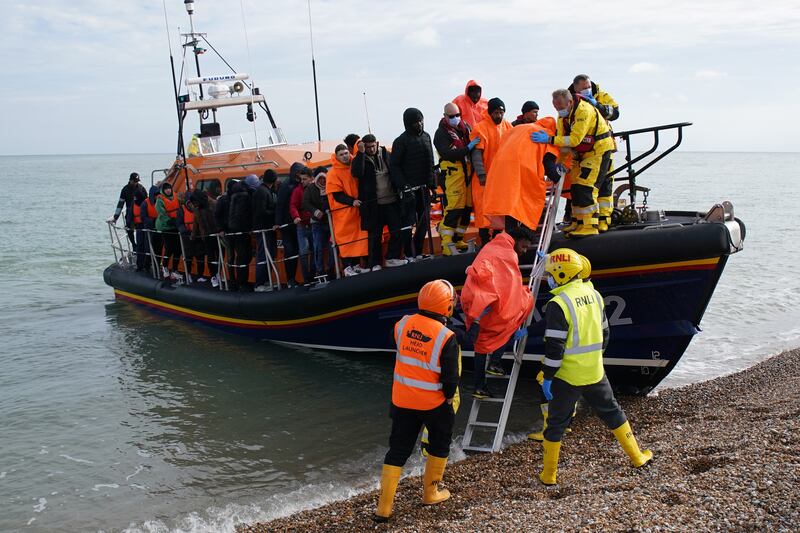 A group thought to be migrants are brought to Dungeness beach in Kent by lifeboat. PA