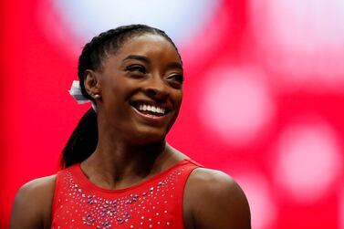 FILE PHOTO: Simone Biles smiles at a teammate during the final day of women's competition in the U. S.  Olympic Team Trials for gymnastics in St.  Louis, Missouri, U. S. , June 27, 2021.   REUTERS / Lindsey Wasson / File Photo