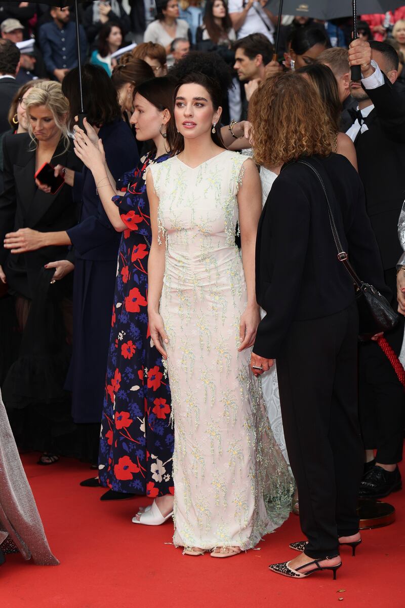 Simona Tabasco wears an embellished, high-necked cream dress. Getty Images